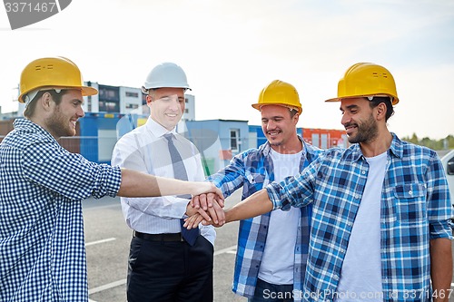 Image of builders and architects with hands on top