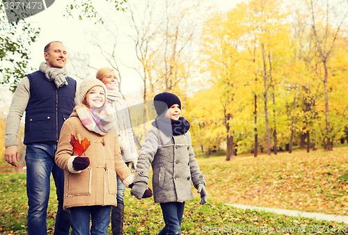 Image of happy family in autumn park