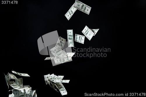 Image of close up of us dollar money flying over black