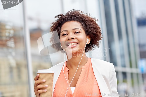 Image of happy african businesswoman with coffee in city