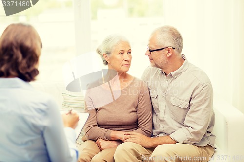 Image of senior couple hugging at home