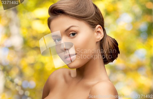 Image of beautiful young woman with bare shoulders