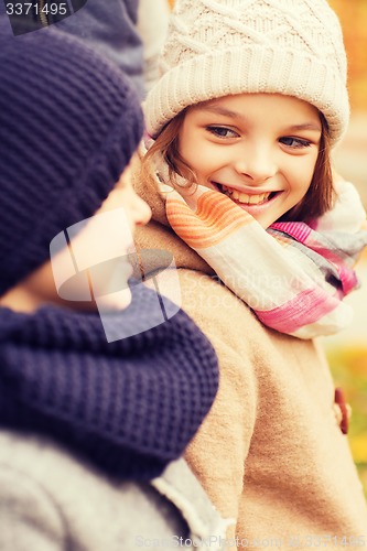 Image of close up of smiling children in autumn park