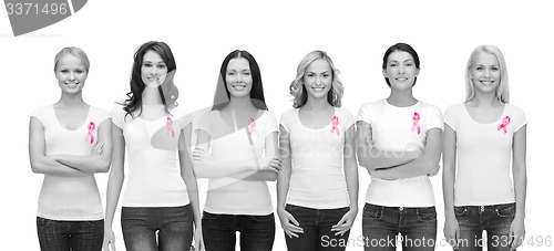 Image of smiling women with pink cancer awareness ribbons