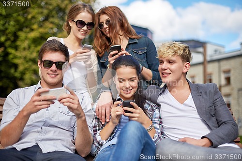 Image of students or teenagers with smartphones at campus