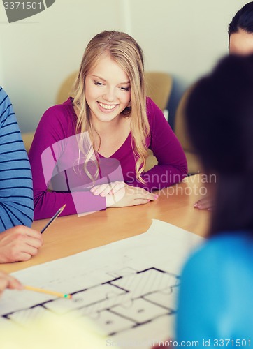 Image of group of smiling students with blueprint