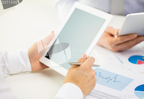 Image of close up of businessman hands with tablet pc