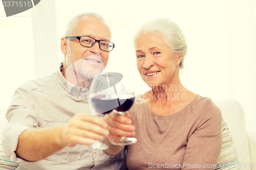 Image of happy senior couple with glasses of red wine