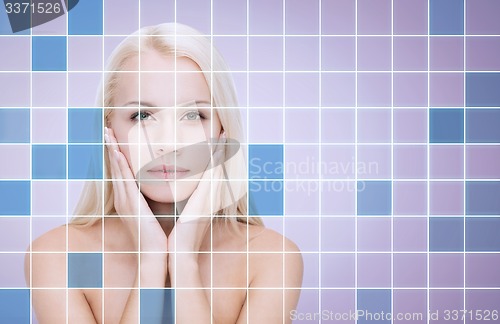 Image of beautiful young woman touching face