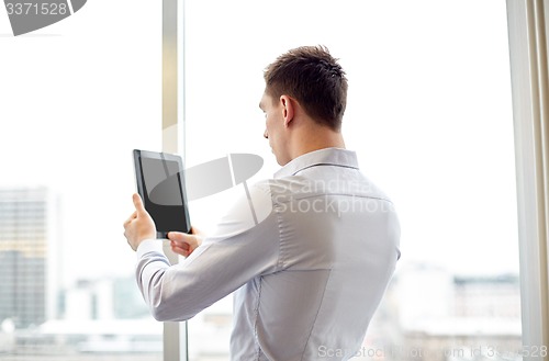 Image of businessman with tablet pc in office