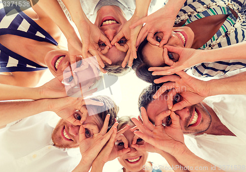 Image of smiling friends in circle