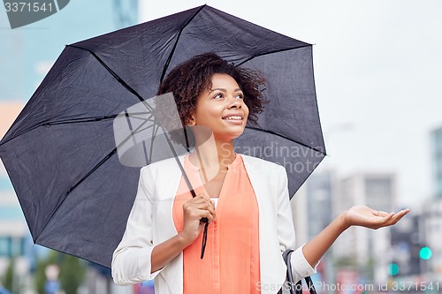 Image of happy african american businesswoman with umbrella