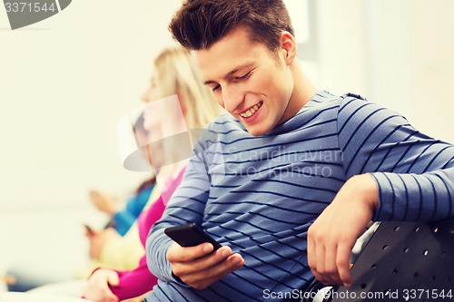 Image of group of smiling students in lecture hall