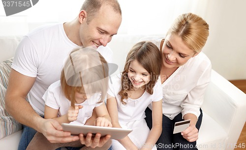 Image of happy family with tablet pc and credit card