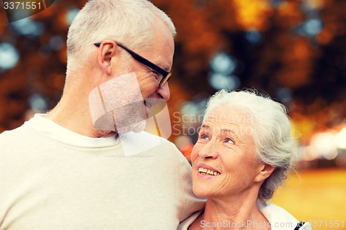 Image of senior couple hugging in city park