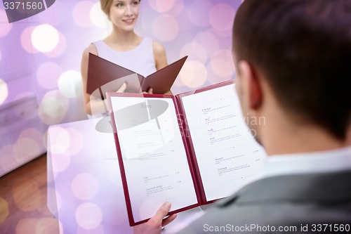 Image of close up of couple with menu at restaurant