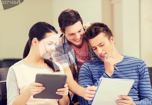 Image of group of smiling students with tablet pc