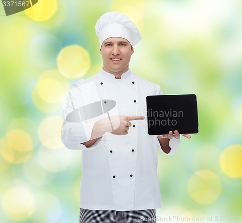 Image of happy male chef cook showing with tablet pc