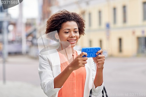 Image of happy african businesswoman with smartphone