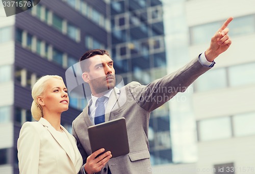 Image of serious businessmen with tablet pc outdoors