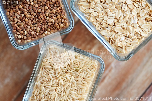 Image of close up of grain in glass bowls on wooden table