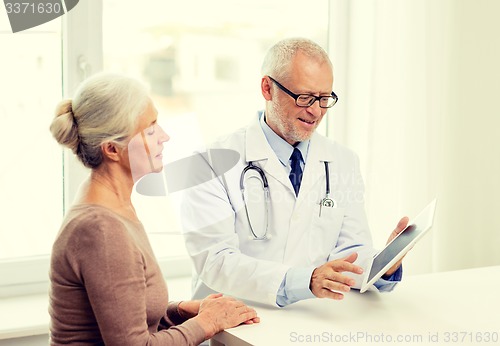 Image of smiling senior woman and doctor with tablet pc