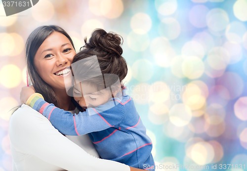 Image of happy mother and daughter hugging