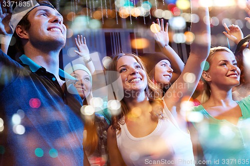 Image of group of happy friends at concert in night club