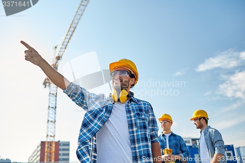 Image of builders pointing finger aside on construction