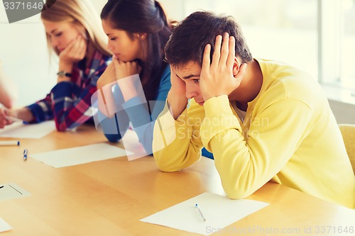 Image of group of students with papers