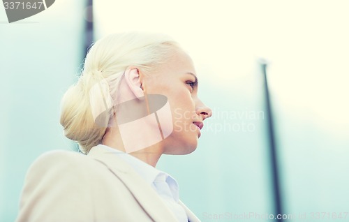 Image of young businesswoman over office building