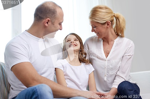 Image of happy parents with little daughter at home