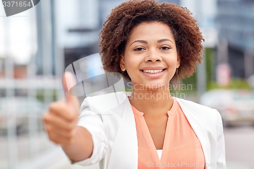 Image of happy young african american businesswoman in city