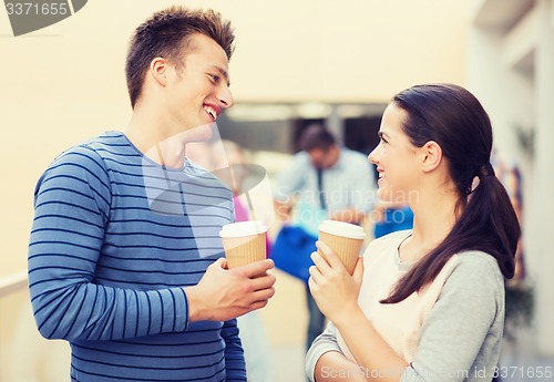 Image of group of smiling students with paper coffee cups