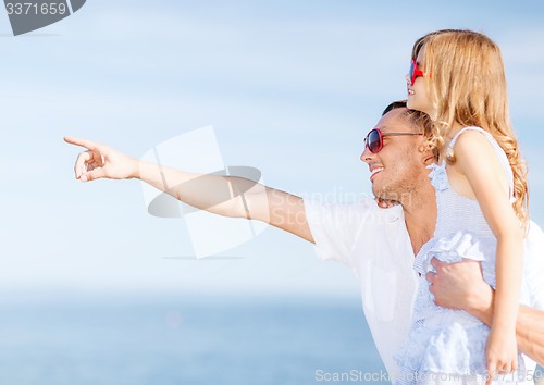 Image of happy father and child in sunglasses over blue sky