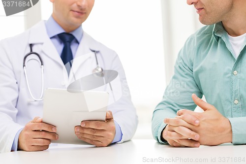 Image of close up of male doctor and patient with tablet pc