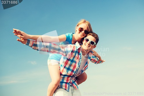 Image of smiling couple having fun outdoors