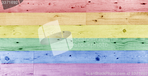 Image of gay pride rainbow flag pattern on wooden surface