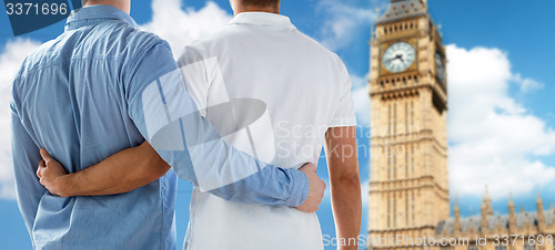 Image of close up of male gay couple hugging over big ben
