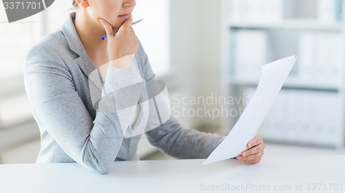 Image of close up of woman reading papers or tax report