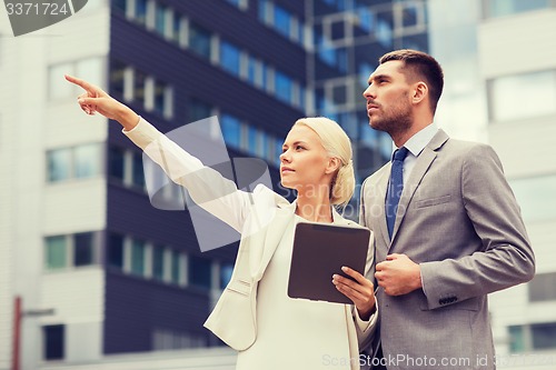 Image of serious businessmen with tablet pc outdoors