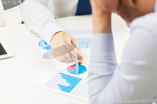 Image of close up of businessman hands with chart