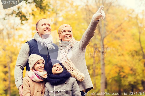 Image of happy family in autumn park