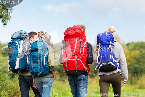 Image of group of friends with backpacks hiking