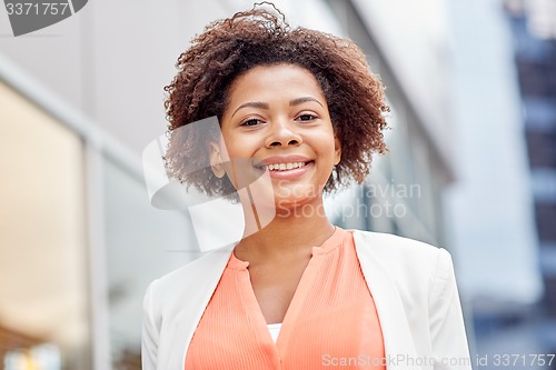 Image of happy young african american businesswoman in city