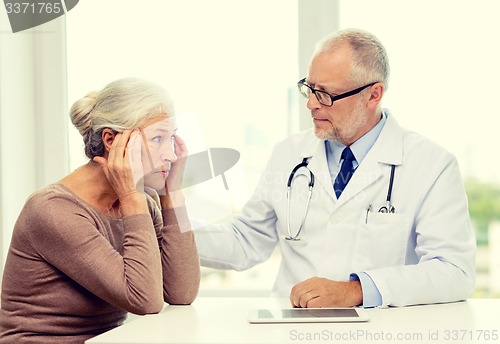 Image of senior woman and doctor with tablet pc
