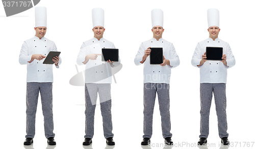 Image of happy male chef cook showing with tablet pc