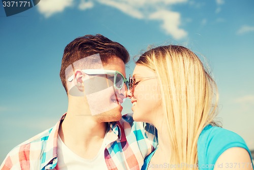 Image of smiling couple having fun outdoors