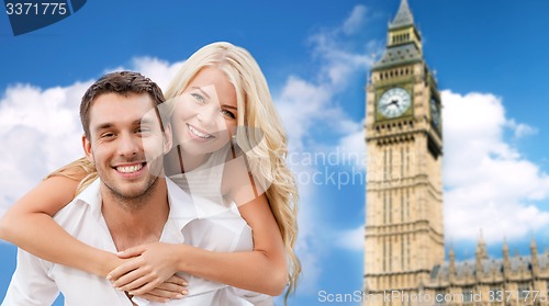 Image of happy couple hugging over london big ben tower