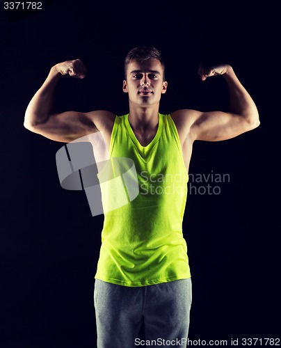 Image of young man showing biceps